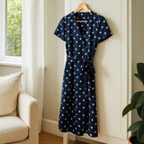 Navy Blue Polka Dot Midi Wrap Dress shown in a typical use setting